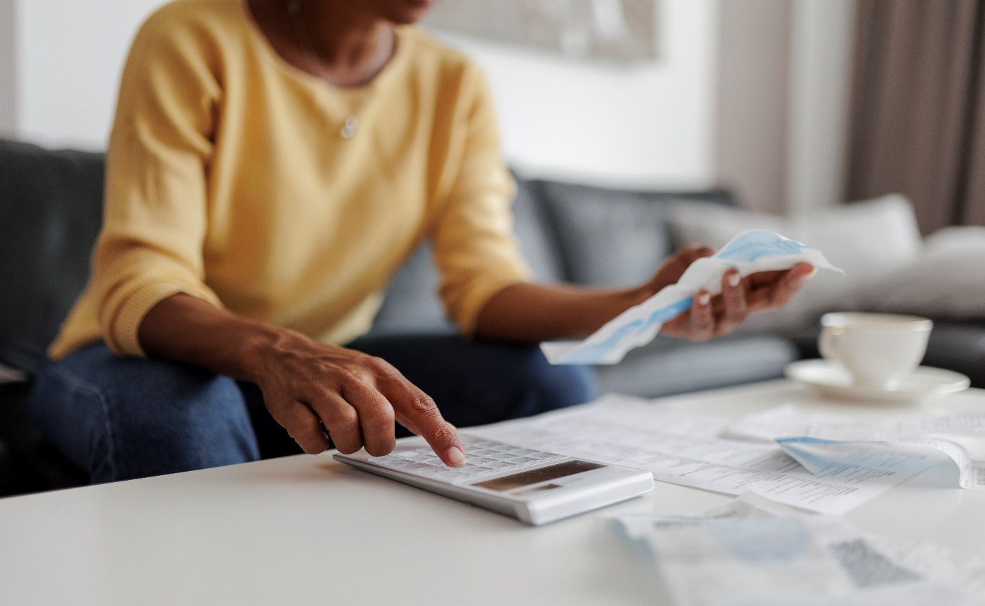 Person doing taxes with calculator